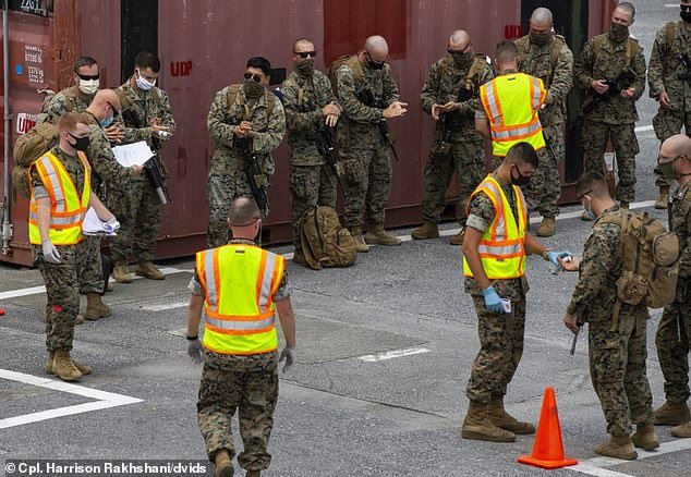 The Northern Territory has not had a new case of COVID-19 detected for more than six weeks and is now effectively considered coronavirus-free. Marines are pictured being screened at Kadena Air Base, Okinawa, on May 15