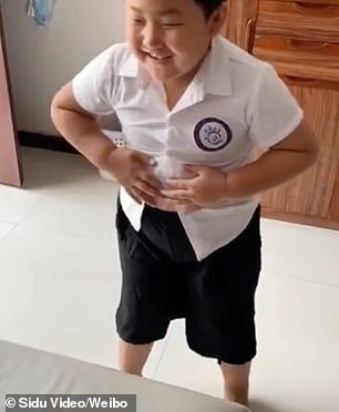 The boy then smiled in relief after he finally put on the school outfit