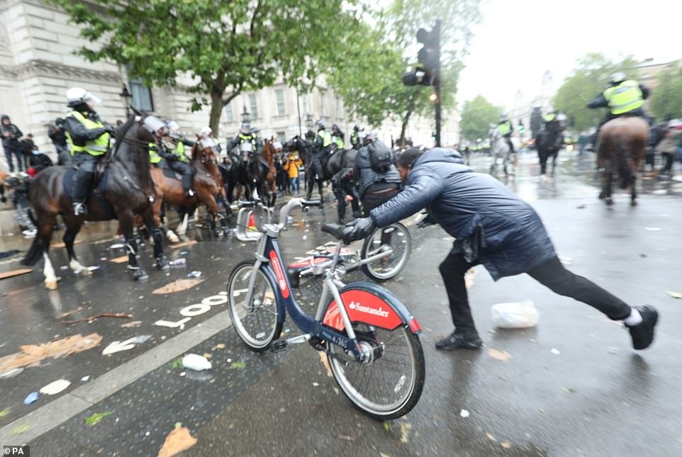 Demonstrators were caught launching bicycles at police horses during violent scenes on Whitehall, central London on Saturday