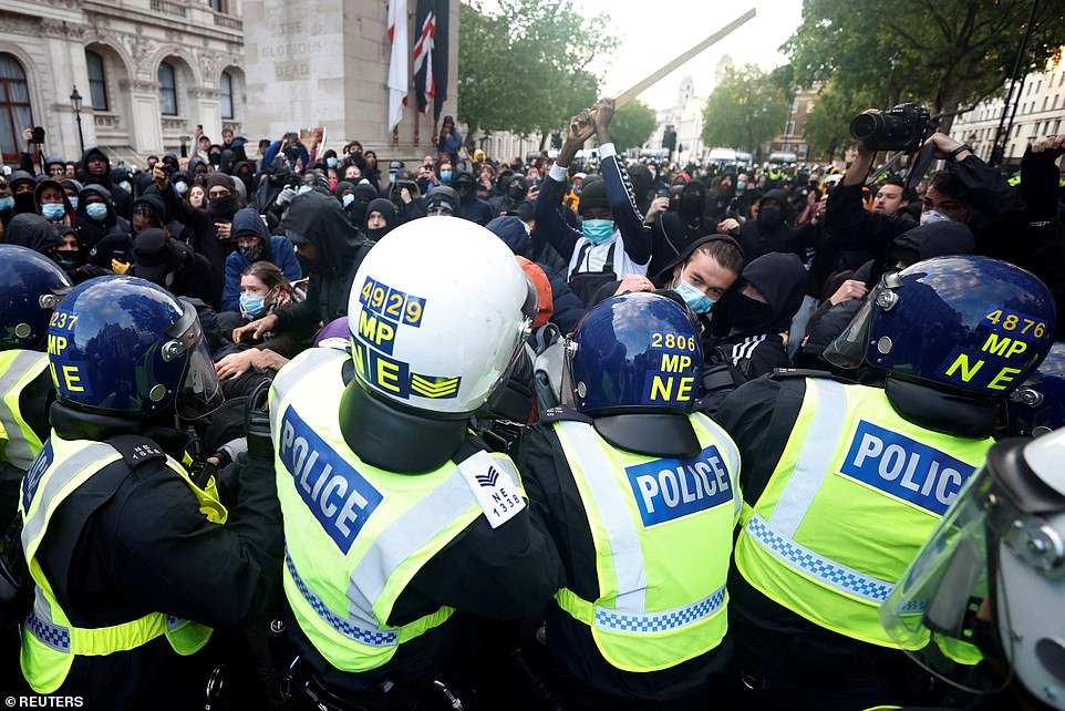 Demonstrators clash with police officers on Whitehall during a Black Lives Matter protest in London. One man was seen with a metal pole