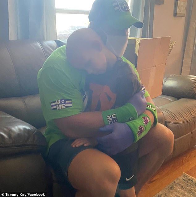 Heartwarming: Cena gave the child a comforting hug amid the turbulent time