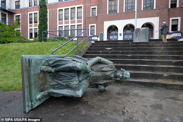 A statue of Thomas Jefferson placed outside of Jefferson High School in Portland, Oregon, was pulled down by a group of protesters on Sunday (pictured)