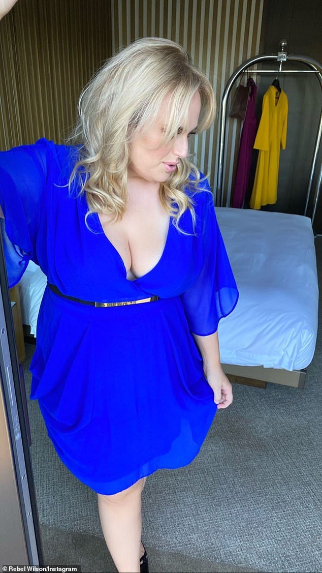 Transformation: The actress oozed confidence as she worked her angles in front of a camera while clad in a belted royal blue dress which plunged down the middle to show off her assets