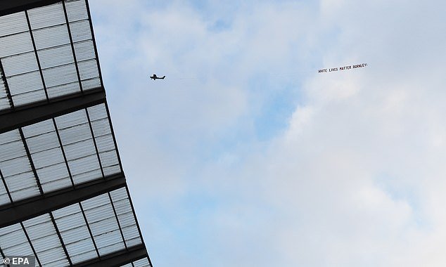 A plane carrying a banner reading 