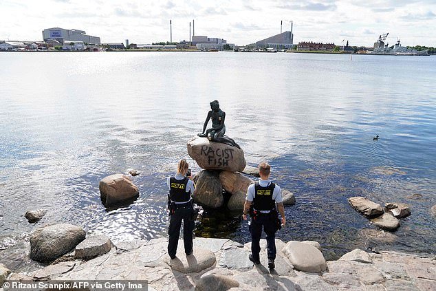 Danish police officers take pictures of the base of the Little Mermaid statue after it was vandalised