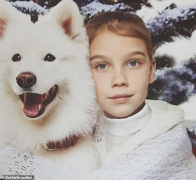 Eight-year-old Vika Teplyakova, pictured with a dog, ran away from home after an argument with her parents, but was picked up by a married couple in their car