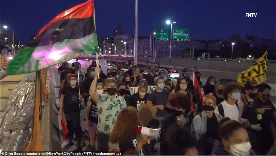 The group, waving flags and chanting, marched onto the bridge on Saturday night