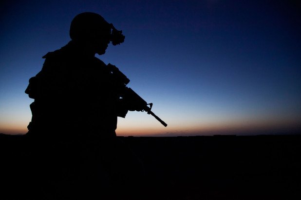 A Navy SEAL team commando provides security during a 2013 night mission in Afghanistan.