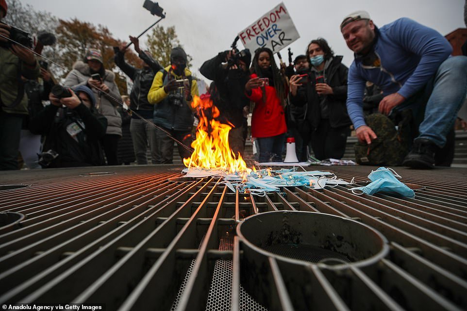 NYC: Anti lockdown protesters burn face masks at the Washington Square Park as they protest coronavirus measurements