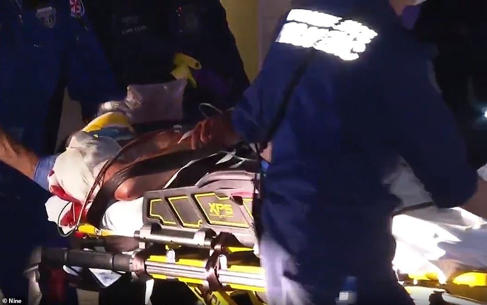 The 22-year-old Scots College Graduate was was treated at the scene before being carried out in a stretcher (pictured above) to St Vincent