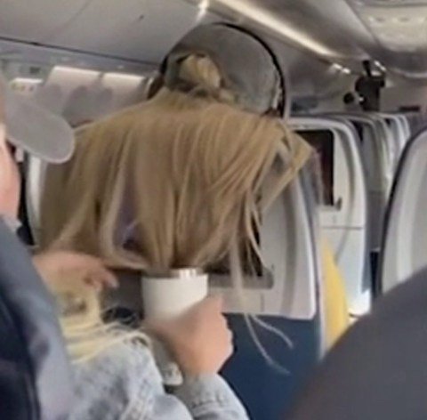 Passenger sticks chewing gum in woman