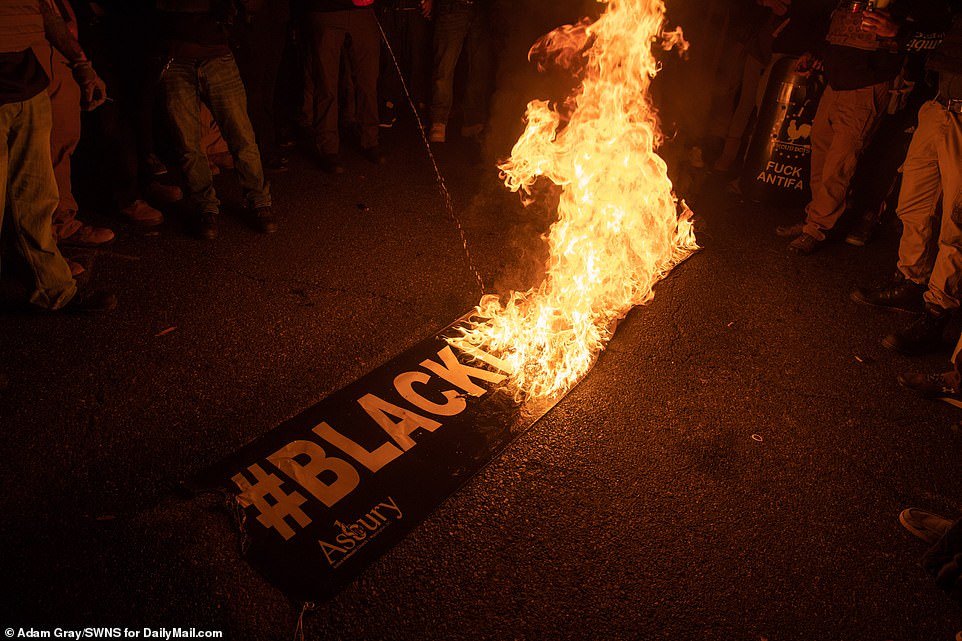 D.C.: Proud Boys burn a Black Lives Matter banner as they marched through the street shouting 