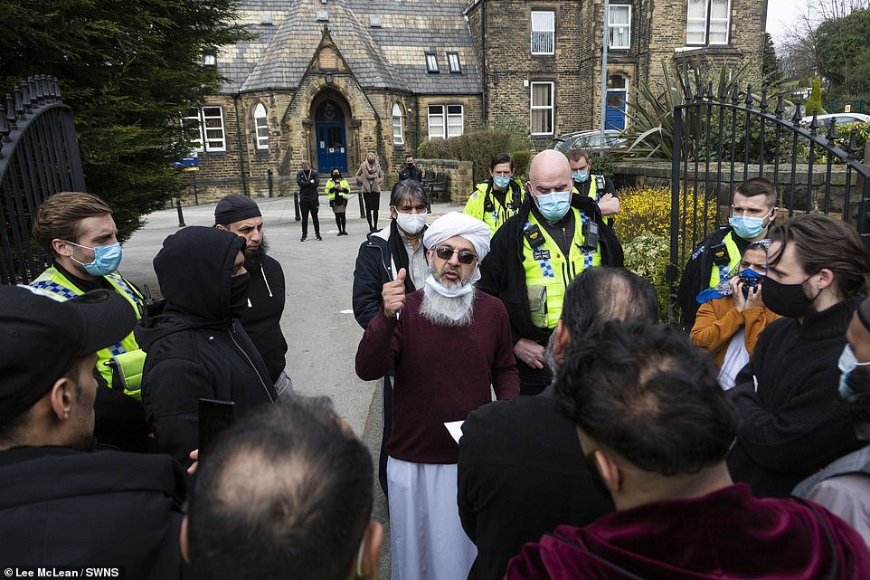 Mufti Mohammed Amin Pandor, a local Muslim scholar, speaks to the crowd gathered outside Batley Grammar School today