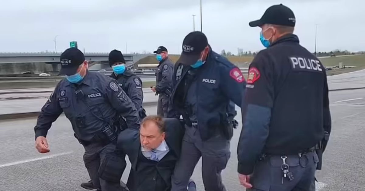pastor4.jpg?resize=412,232 - Police Arrest Pastor And Drag Him Across The Road For Organizing An 'Illegal Service'