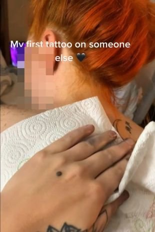 A woman who has just received a tattoo
