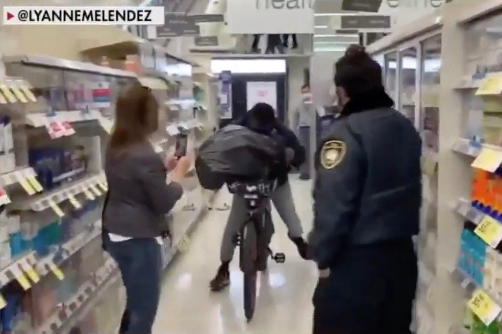 A shoplifter on a bike stealing items from a San Francisco Walgreens.