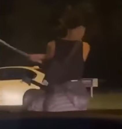 Footage showed him holding the sword as paced up and down the road in front of dozens of cars