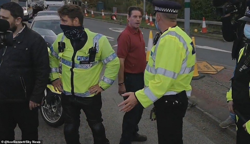 During the Insulate Britain protest in Dartford today, police had to hold some of the drivers back and warned them they could be arrested for assault if they touched the activists. One irate motorist (in red shirt) was heard on Sky News telling an officer: 
