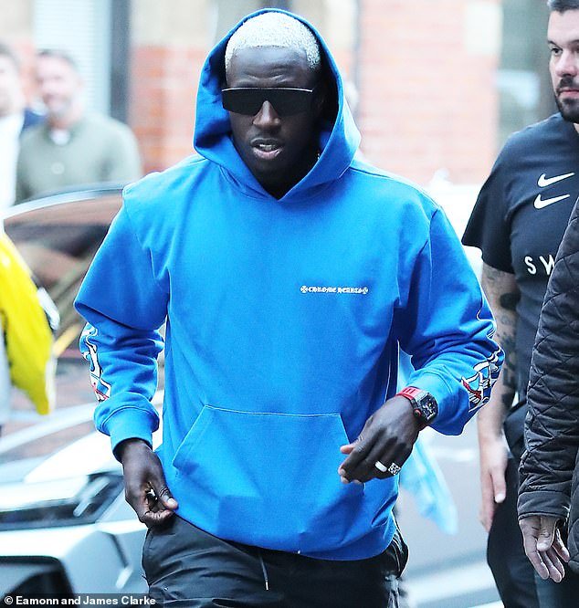 Benjamin Mendy is pictured on August 12 out with his teammates at The Ivy in Manchester. He is now in custody and accused of six rapes - two more charges were announced today