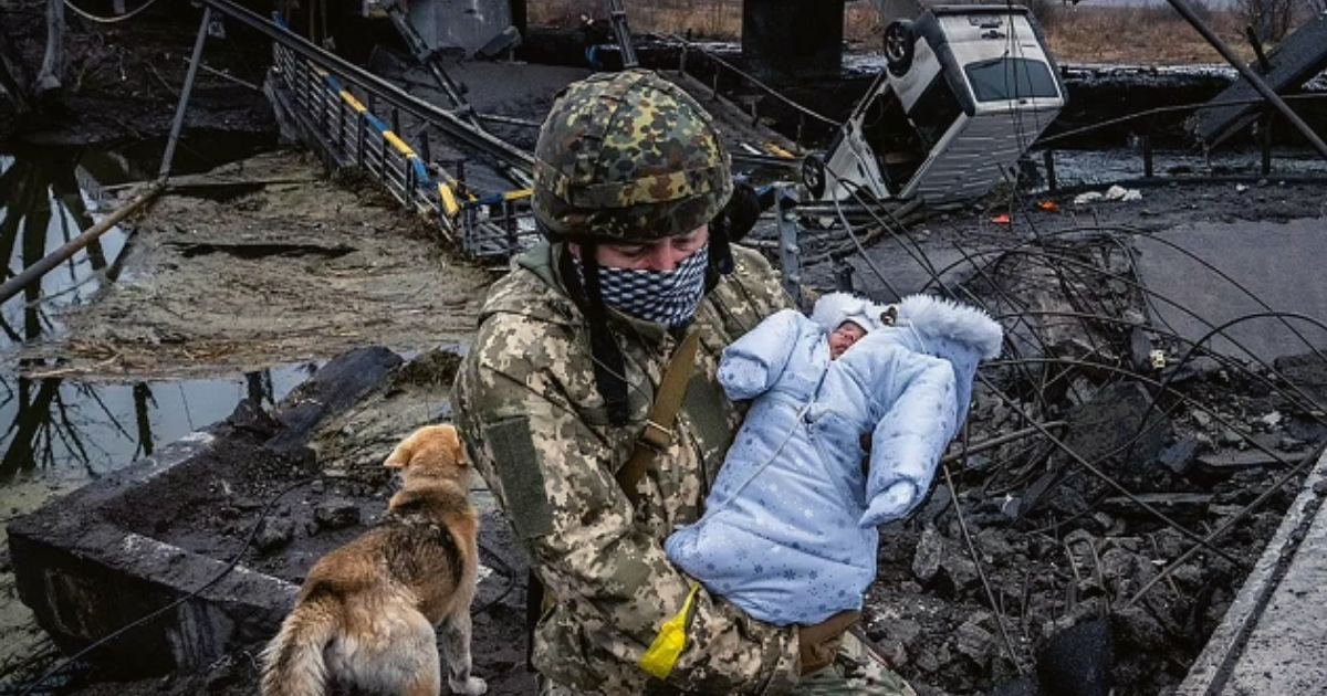 baby6.jpg?resize=412,275 - Photo Of A Baby Being Carried By A Ukrainian Soldier After Invasion Has Reduced Many Cities To Rubble