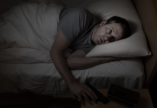 Worried man grabs gun from night stand while in bed