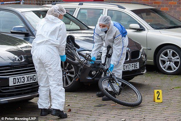 A murder investigation has today been launched after a cyclist was chased down and killed after being involved in a crash with a car. Pictured: Police forensic teams at the scene today