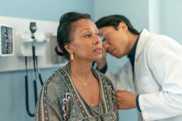 Mature Adult Woman Has Ears Checked By Doctor At Routine Medical Appointment Stock Photo - Download Image Now - iStock