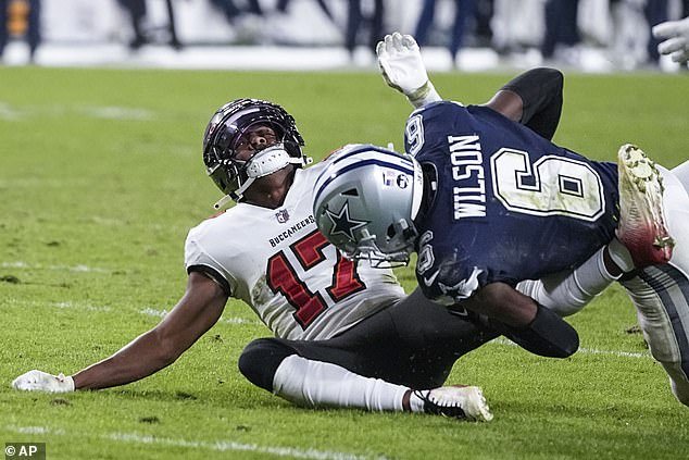 Tampa Bay Buccaneers wide receiver Russell Gage (17) is hit by Dallas Cowboys safety Donovan Wilson (6) during the second half of an NFL Wildcard round game
