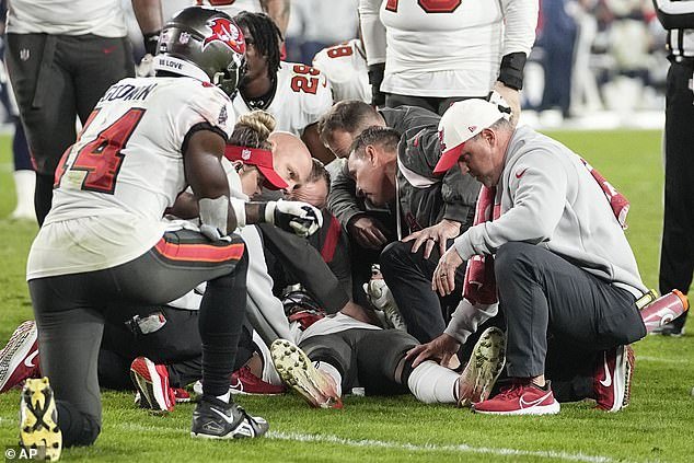 Russell Gage is examined on the turf as stunned teammates look on during Monday