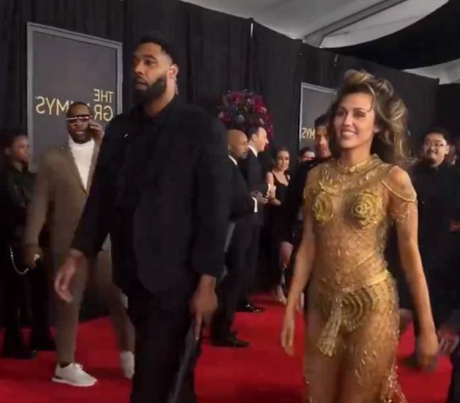 The clip shows Cyrus walking down the red carpet into the ceremony accompanied by her bodyguard who is holding an umbrella. Credit: Matt Wallace/X