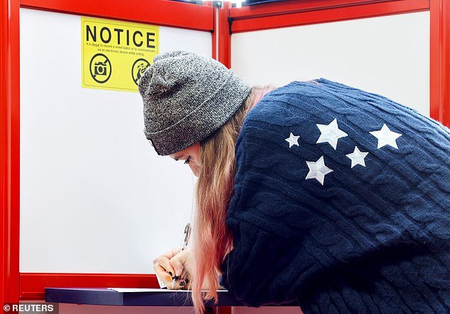 A woman votes during the 2024 U.S. presidential election on Election Day, in Arden, North Carolina