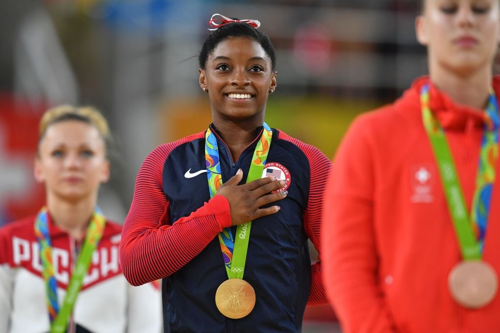 Simone Biles wearing a gold medal